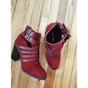 Red booties with faux leather buckles and straps